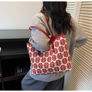Detail view of red festive tote bag with traditional double happiness jacquard pattern