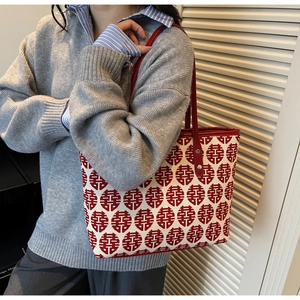Detail of red festive Double Happiness pattern on large canvas tote bag with leather straps