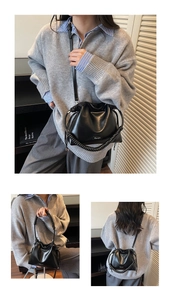 Detail of black drawstring bucket bag showing spiral handle and versatile carrying styles