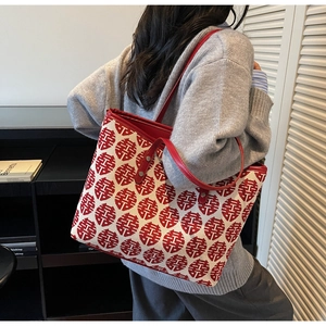 Detail of red and white Double Happiness jacquard tote bag with leather straps