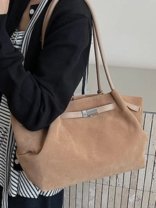 Minimalist camel suede bucket bag with leather shoulder straps and silver metal buckle