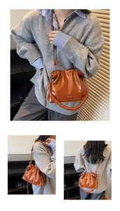 Detail view of caramel brown pleated cloud bag with twisted handle and shoulder strap