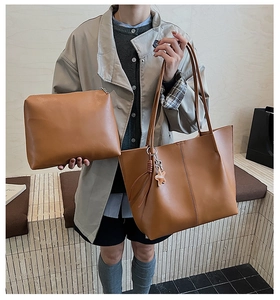Brown leather tote bag set including a large shopper and a matching small zipper pouch