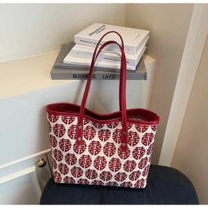 Detail of red wedding character jacquard on canvas tote with faux leather handles