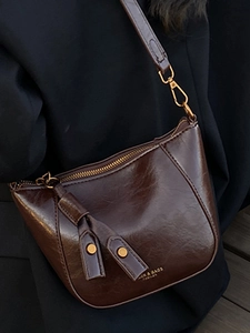Minimalist vintage dark brown crossbody bag with glossy leather finish and wide strap