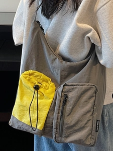 Fashionable dark grey large capacity crossbody bag with yellow drawstring pocket