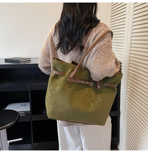 Detailed back view of a large olive green suede tote bag showing its texture and scale