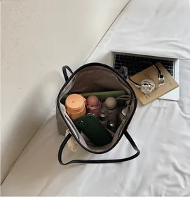 Top view of spacious grey tote bag interior filled with daily items for work commute