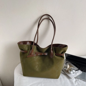 Vintage olive green matte tote bag with brown leather handles and decorative belt detail