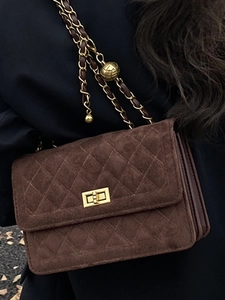 Brown quilted suede flap bag with gold chain strap and adjustable golden ball