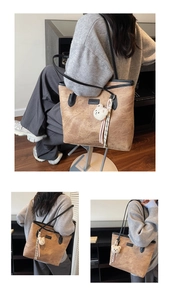 Detailed macro view showing the vintage bear embossed texture of the brown tote bag