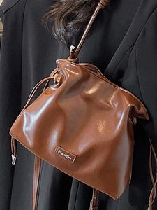 Chic brown drawstring leather bucket bag for women featuring a soft pleated texture