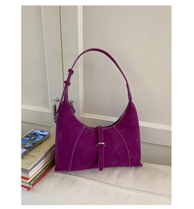 Detail shot of purple suede hobo bag with contrast stitching and metal buckle decoration