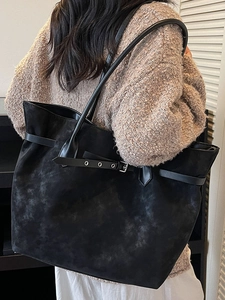 Chic 2025 large black tote bag in washed faux suede texture worn on shoulder by model