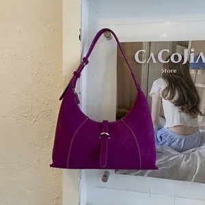 Detail view of purple suede hobo bag featuring white contrast stitching and metal buckle