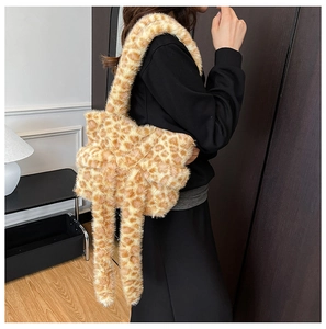 Detail view of large plush leopard print bow tote bag with soft faux fur shoulder strap