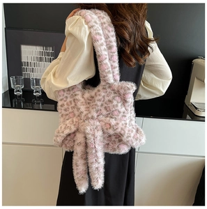Detail view of pink leopard faux fur tote bag with a large bow on the side and soft texture