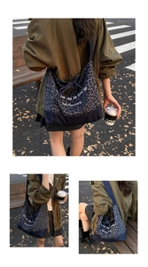 Detail of leopard print denim tote bag featuring drawstring closure and patchwork design