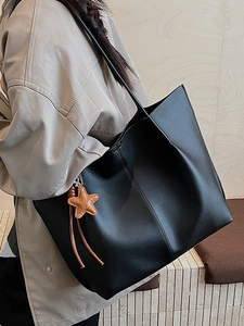 Minimalist large black tote bag with brown star charm for women in 2025 commute style