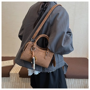 Retro brown suede handbag with decorative beads and crossbody strap shown on model