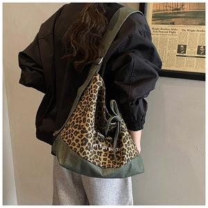 Detail of vintage leopard print denim tote bag with dark green canvas trim and wide strap