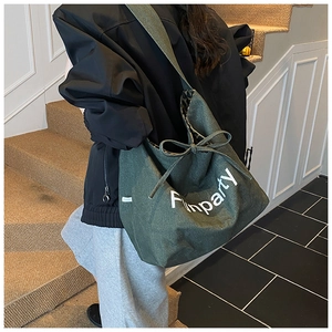Detailed view of the dark green canvas tote bag featuring leopard print lining and a bow