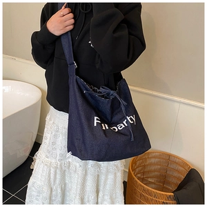 Detailed view of the large denim tote bag with Funparty lettering and drawstring closure