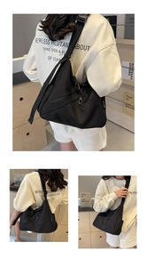 Macro view of black nylon crossbody bag featuring wide adjustable strap and zipper pockets