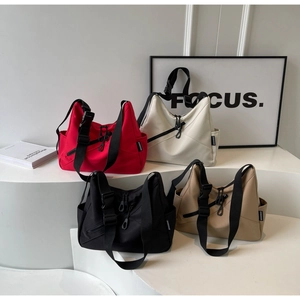 Four versatile nylon crossbody bags in red, white, black, and khaki with wide straps