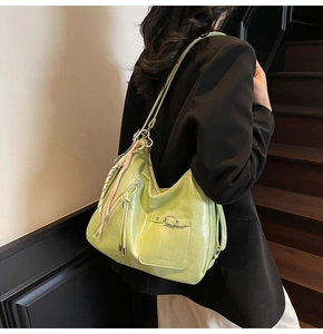 Detail view of lime green leather tote bag with silk scarf and decorative fringe detail