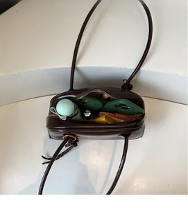 Detail view of the spacious inner compartment of this vintage dark brown tote bag