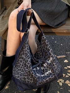 Large denim tote bag with vintage leopard print patches and stylish shoulder straps
