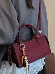 Vintage burgundy leather handbag with silver studs and colorful beaded fringe tassel