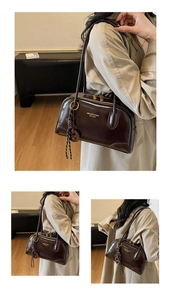 Detail of dark brown polished leather bowling bag with vintage branding and gold hardware