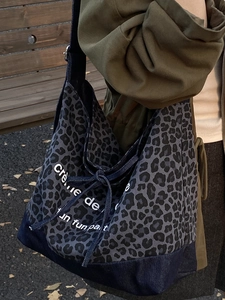 Retro denim tote bag featuring leopard print, drawstring closure, and large capacity