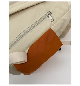 Détail de sac à dos en toile imperméable avec poche orange et fermeture éclair métallique