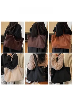 Detailed view of large faux suede tote bags in brown, khaki, and black colors