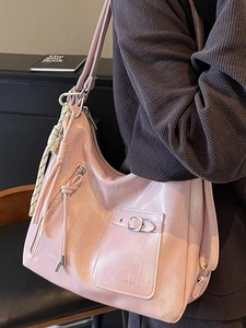 Chic pink faux leather shoulder bag for women featuring a stylish tassel and side zipper