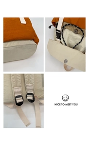 Detail view of nylon backpack showing reinforced stitching and adjustable shoulder straps