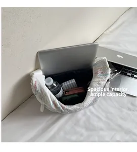 Spacious interior of white quilted shoulder bag showing laptop and daily essentials storage