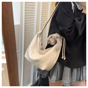 Minimalist white leather tote bag featuring a cute grey rabbit plush charm accessory
