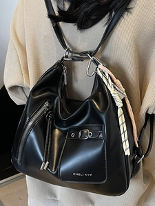 Elegant black leather tote bag for women with silver zippers and stylish knot charm