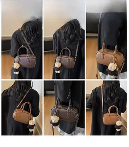 Detail shots showing the versatile styling of the retro Boston bag with a teddy bear charm