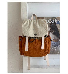 Détail d'un sac à dos d'extérieur avec rabat crème et tissu en nylon de couleur orange brûlé