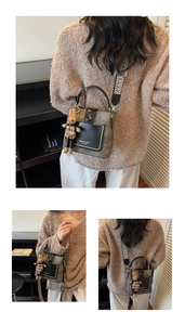 Detail of vintage bucket bag with monogram texture and cute rabbit plush charm