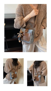 Detailed view of denim and brown leather vintage bucket bag with rabbit charm and woven strap