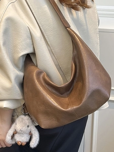 Brown PU leather hobo shoulder bag with plush rabbit pendant in a minimalist design