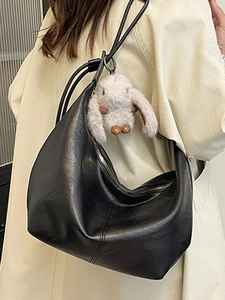Minimalist large black hobo shoulder bag in shiny PU leather with plush rabbit charm