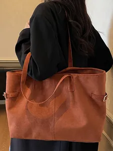 Brown suede tote bag with adjustable side buckles and large capacity for daily commuting