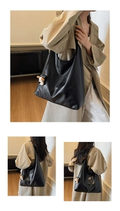 Detail view of large black glossy leather tote bag with a cute dog plush charm accessory